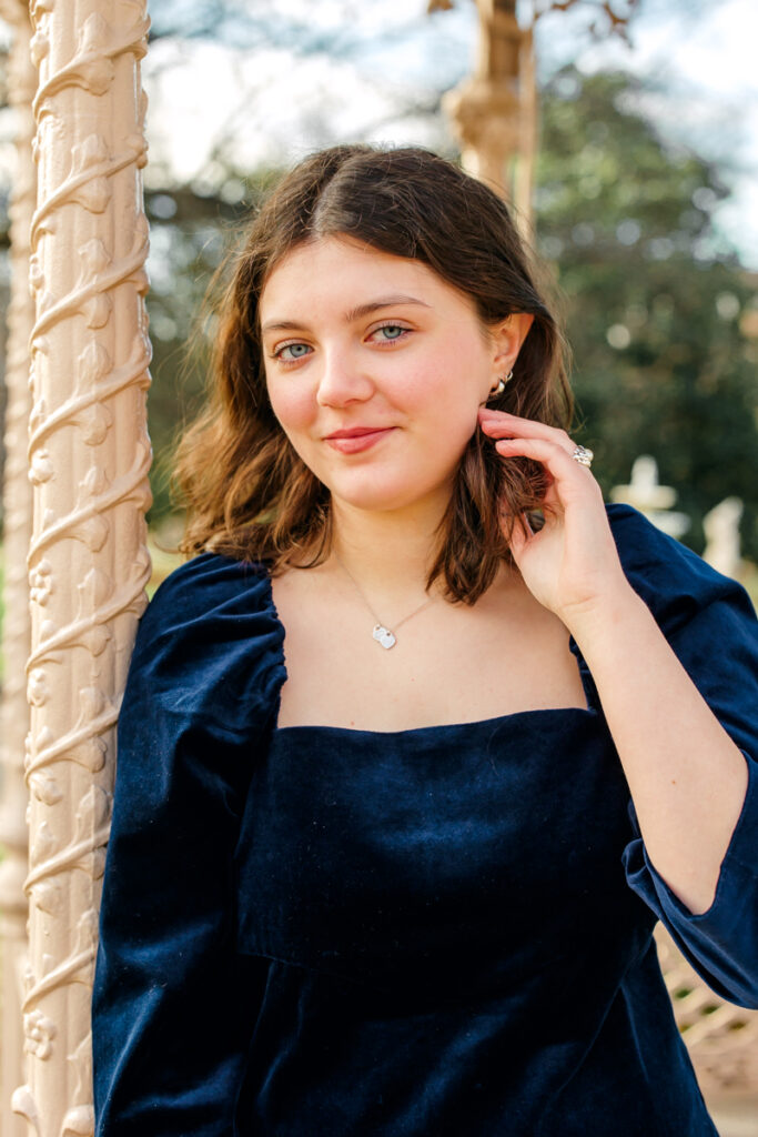 Close-up of college senior brushing her hair back.
