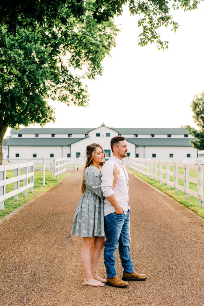 Couple gazing into the distance while standing on the main entry path at Harlinsdale Farm