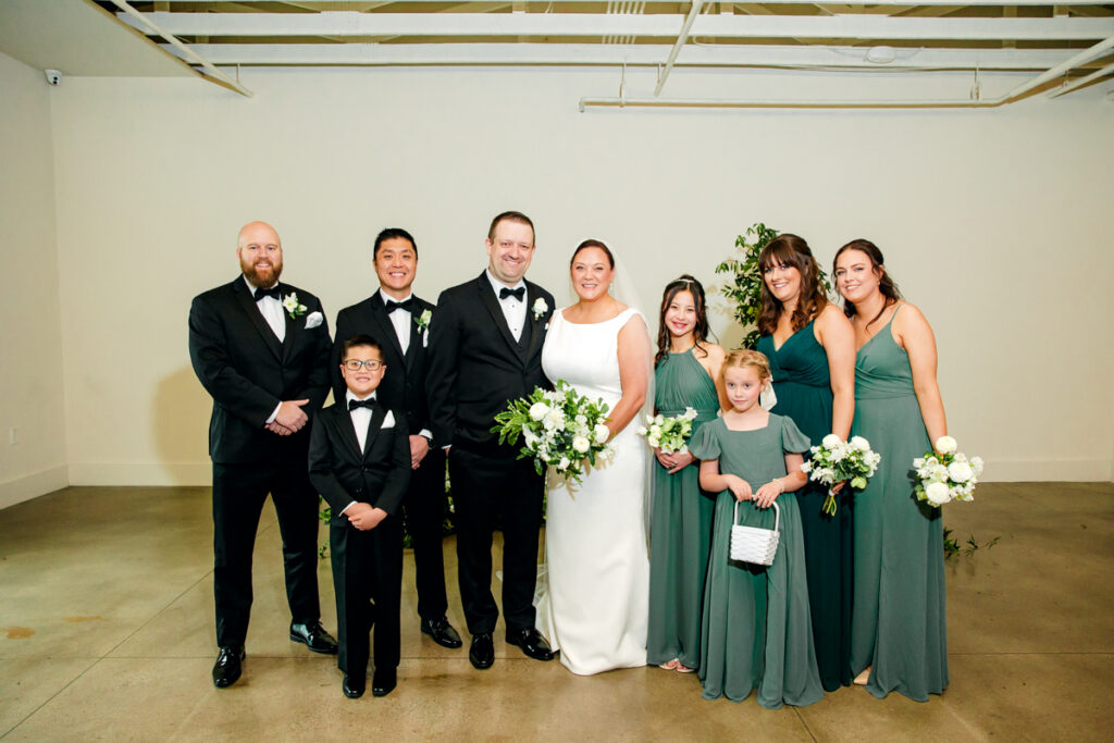 Bride and groom with their full wedding party at Saint Elle