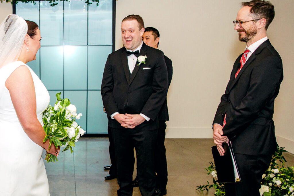 Groom reacting to his bride coming down the aisle