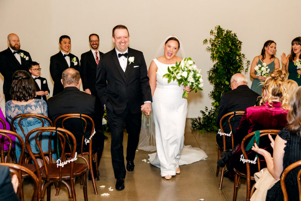 Bride and groom happily exit their ceremony