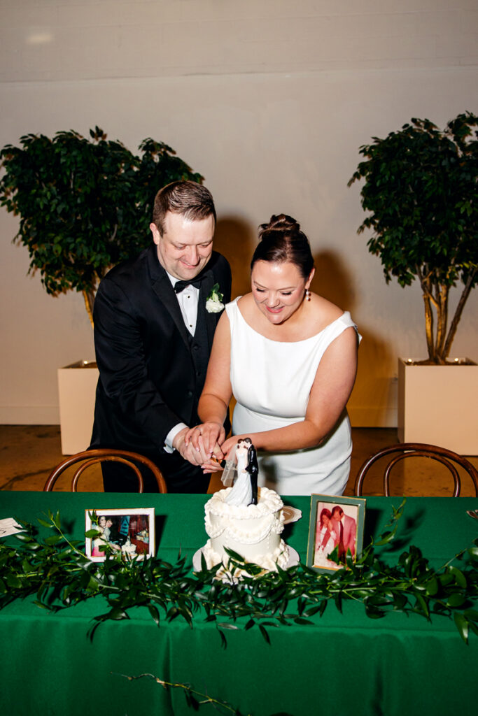 Bride and groom cutting their wedding cake during their Saint Elle wedding reception in Nashville