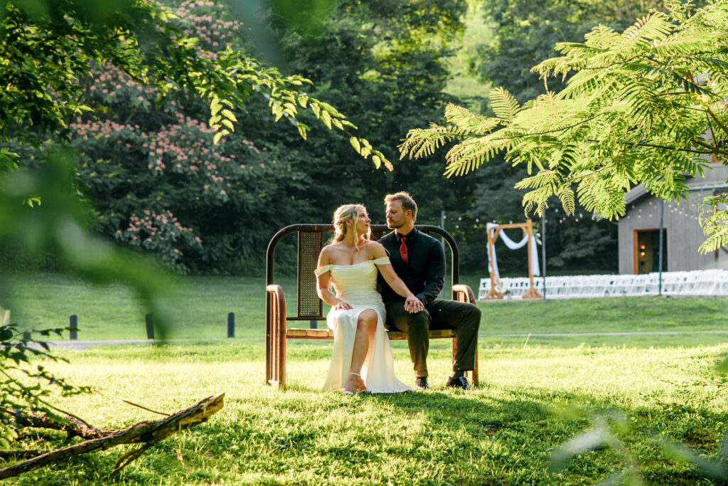 Bride and groom sitting on bench at 4 Points Farm in Sevierville, TN