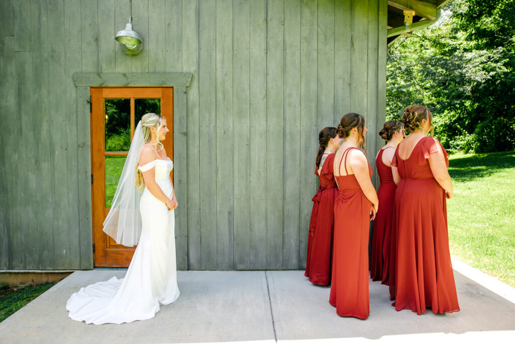 Bride and bridesmaids moments before the bride reveals her dress