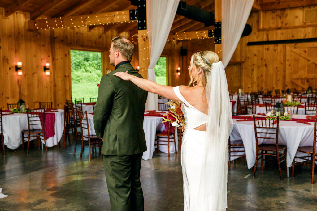 Bride gently tapping the groom on his shoulder to signal him to turn