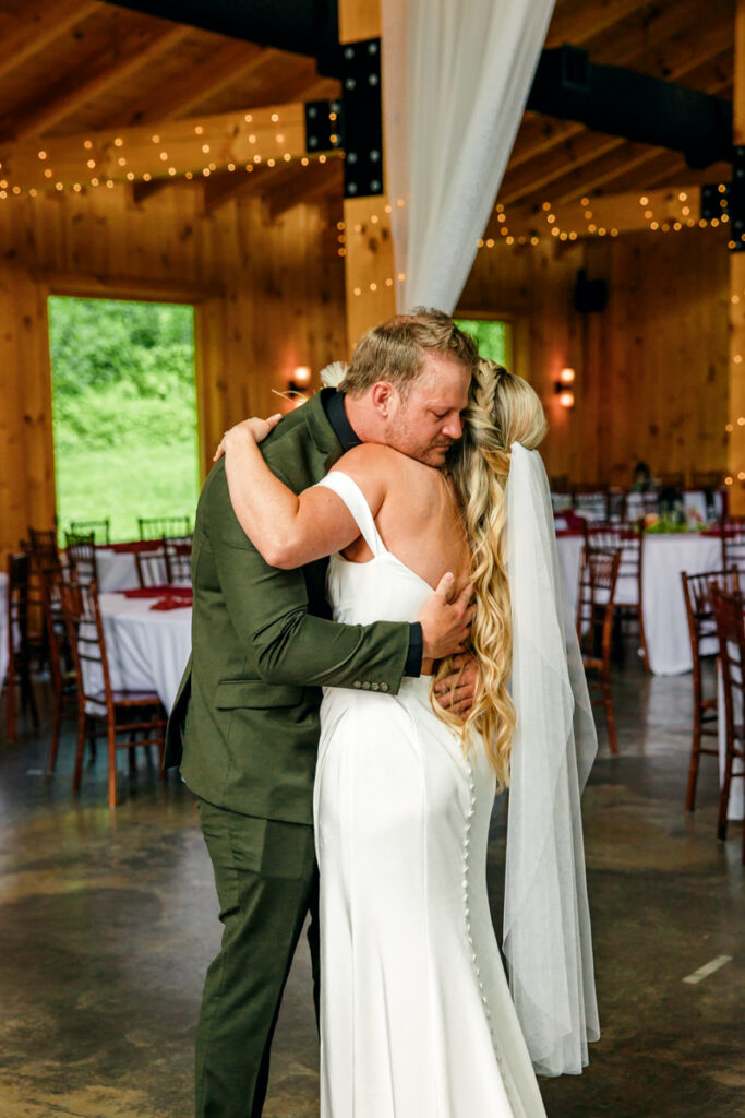 Bride and groom sharing a hug during their first look at 4 Points Farm