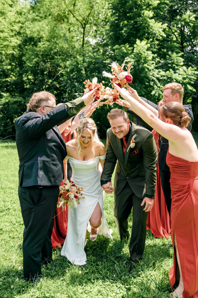 Wedding party creates a tunnel for the bride and groom to run through