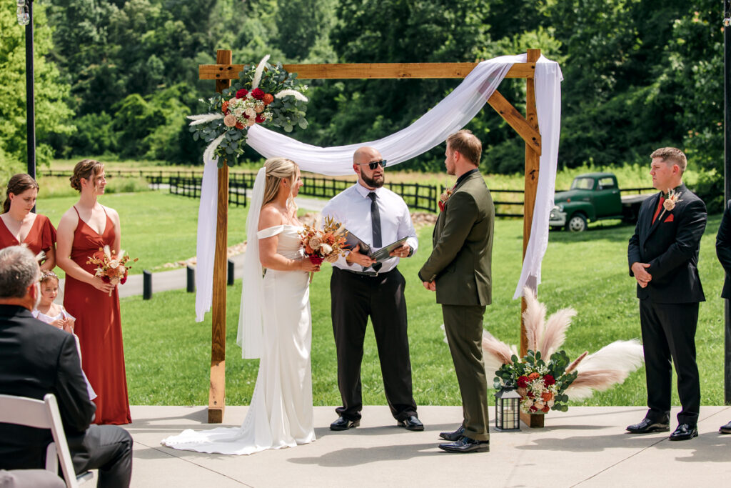 Bride and groom reciting their vows during outdoor ceremony at 4 Points Farm