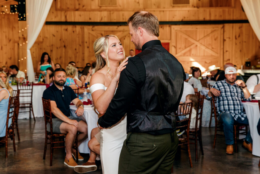 Bride smiling at her groom during their first dance
