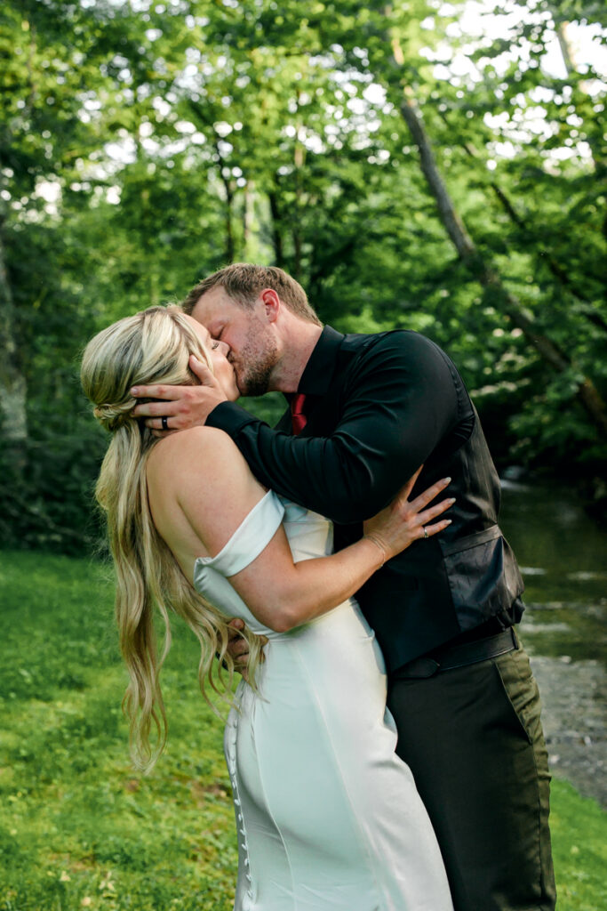 Bride and groom passionately kissing during their newlywed portraits at 4 Points Farm