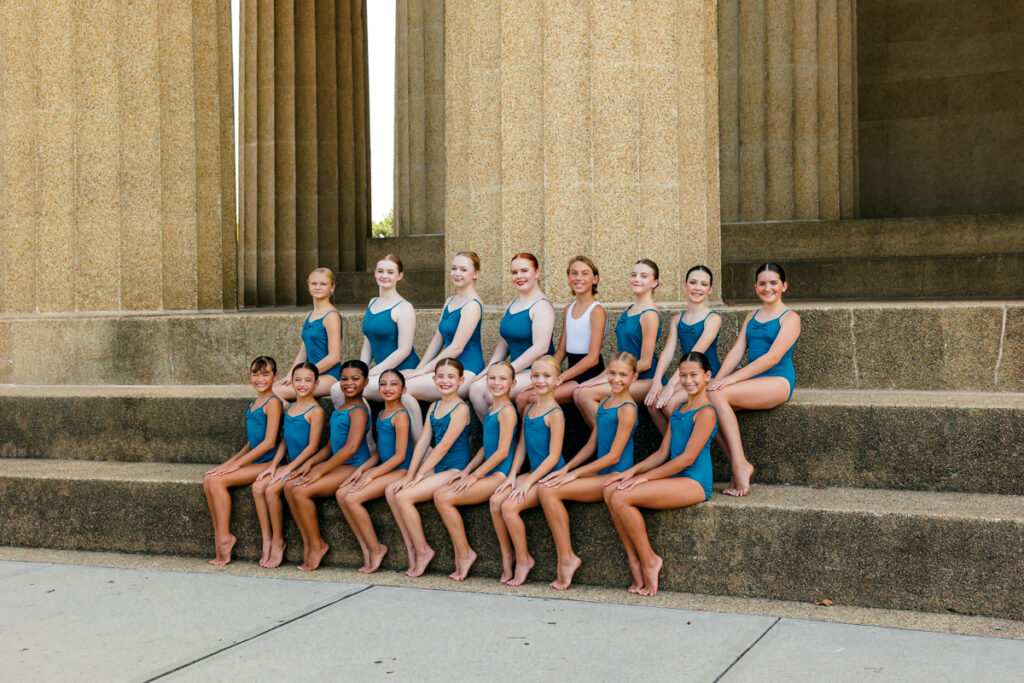 Group of dancers sitting on the steps at The Parthenon