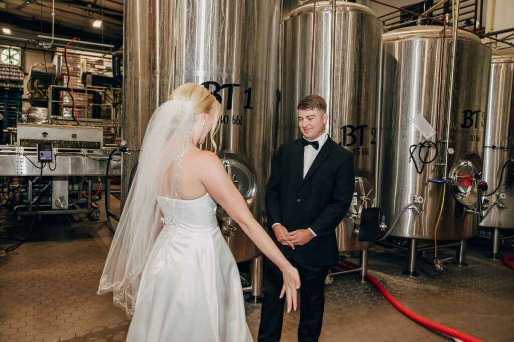 Groom seeing his bride for the first time on their wedding day