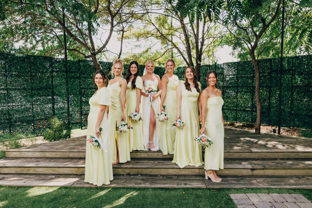 Bride posing with her bridesmaids before the wedding ceremony