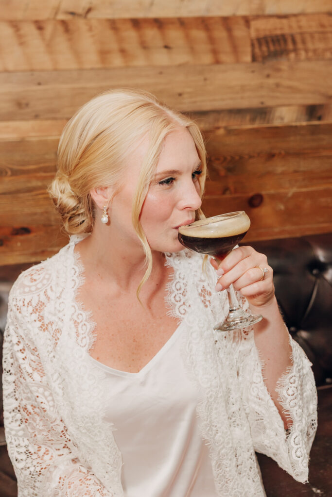 Bride sipping a drink in her pjs