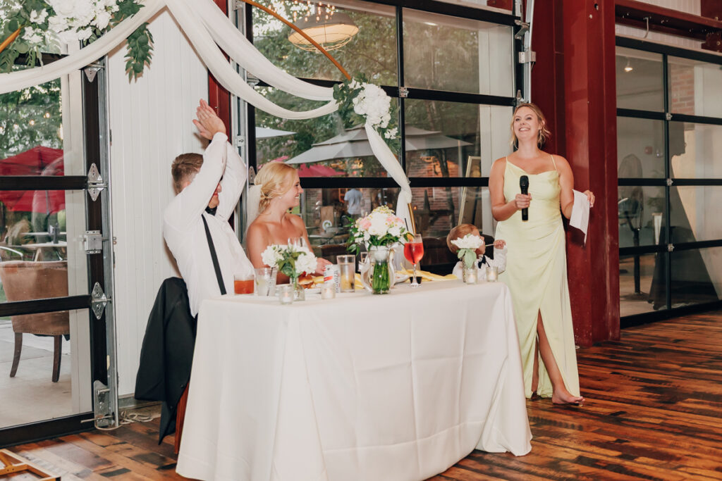 Maid of honor giving a speech at a wedding reception
