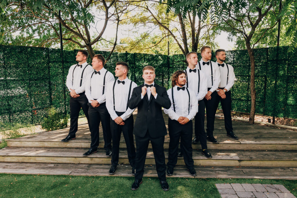 Groom posing with his groomsmen before the ceremony