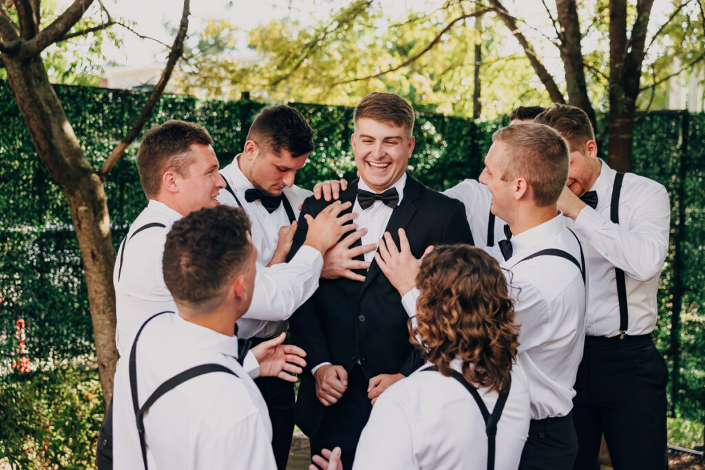 Groom surrounded by best man and groomsmen