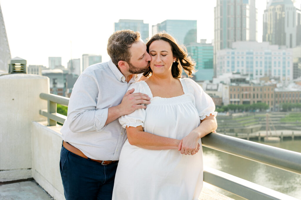 Man kissing his fiancée on the cheek during a Nashville, TN engagement session
