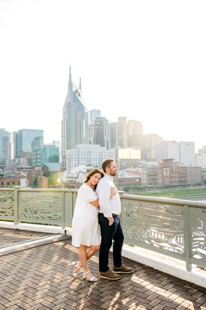 Engaged couple posing in an alcove on Nashville Pedestrian Bridge