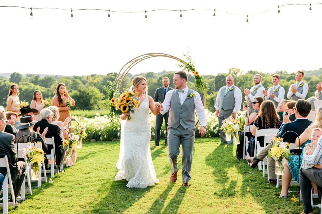 Bride and groom walking back down the aisle after their outdoor ceremony at Allenbrooke Farms