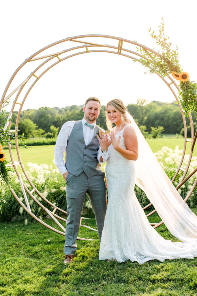Bride and groom showing off their wedding rings