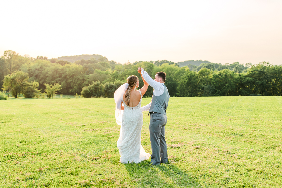 Groom twirling his bride on their wedding day at Allenbrooke Farms in Spring Hill, TN