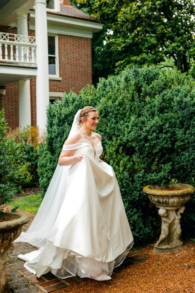 Bride walking through the gardens at Homestead Manor