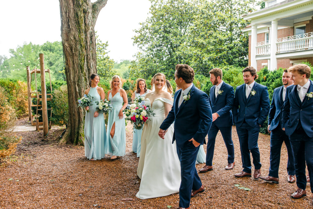 Bride and groom with full wedding party at Homesad