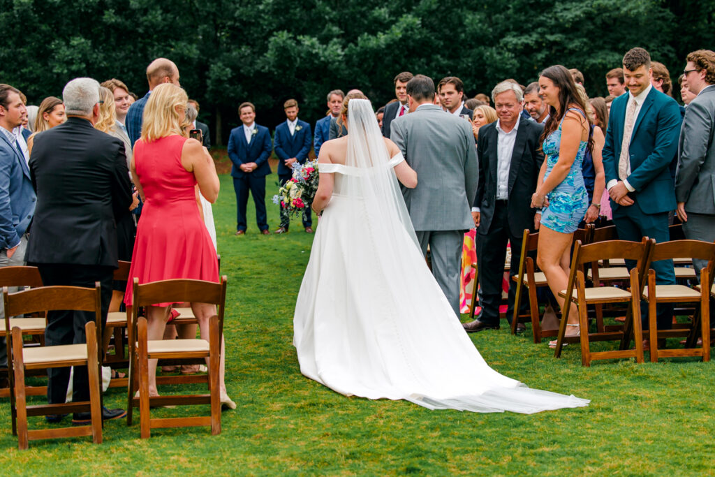 Bride walking down the aisle with her dad at Homestead Manor.