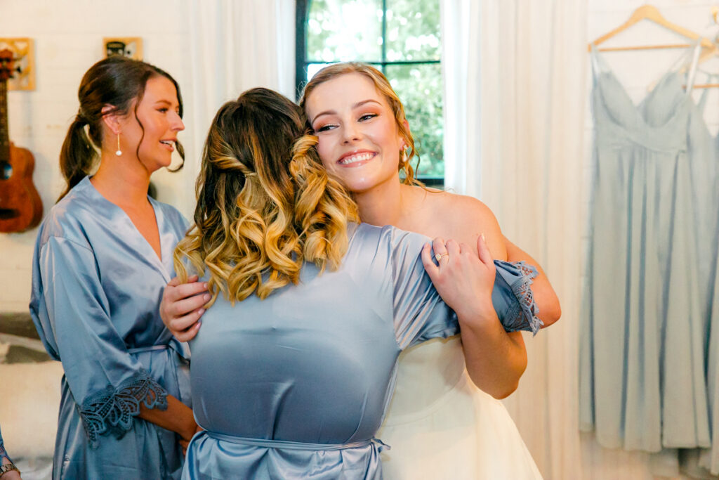 Bride hugging her bridesmaid in the bridal suite at Homestead Manor