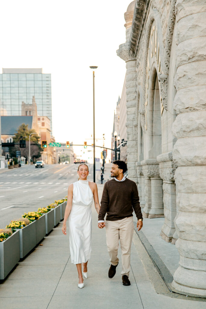 Engaged couple walking in Downtown Nashville during their Union Station engagement session
