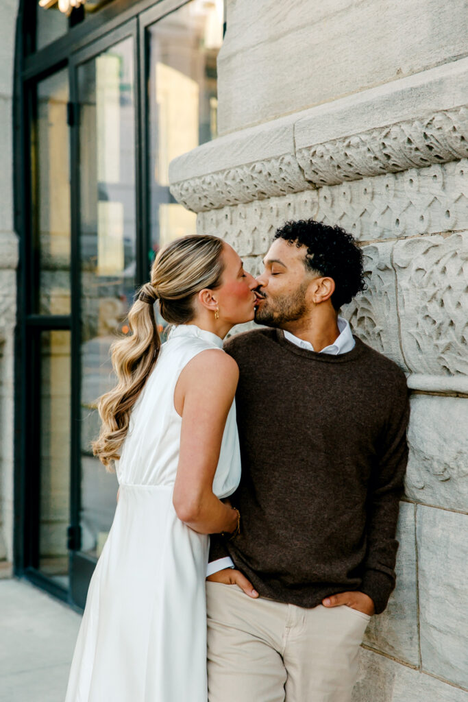 Couple kissing during their engagement session in the heart of downtown Nashville