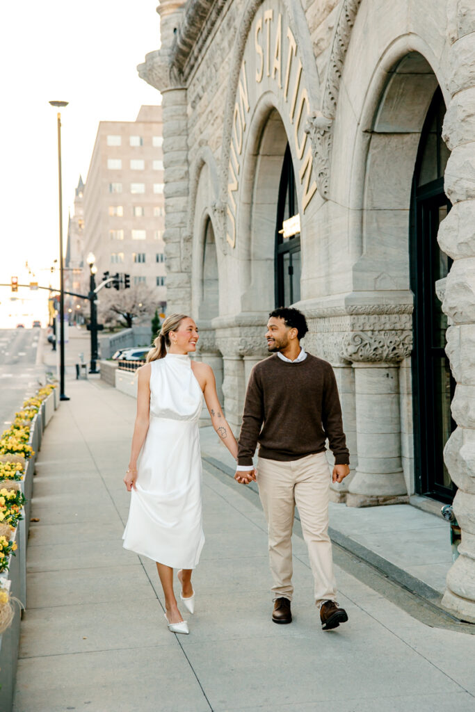 Engaged couple gazing at each other while they walk down Broadway in Downtown Nashville