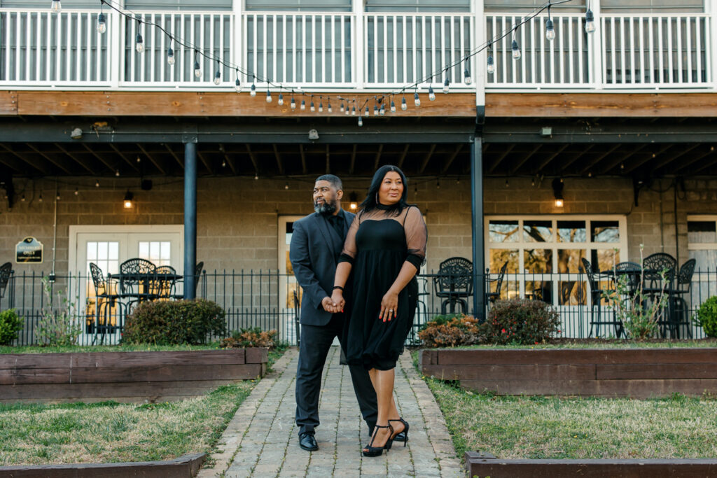 Black engaged couple looking away from each other on a sunny day in Hendersonville, TN.