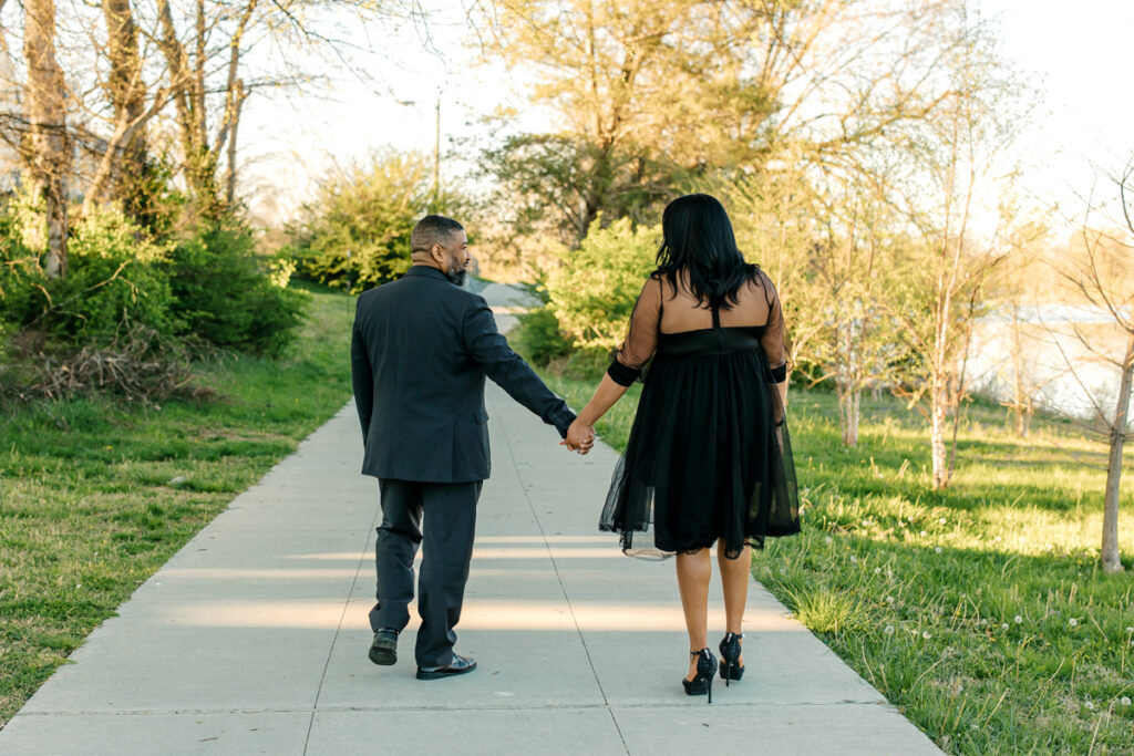 Engaged couple holding hand and walking along the lake in Hendersonville, TN