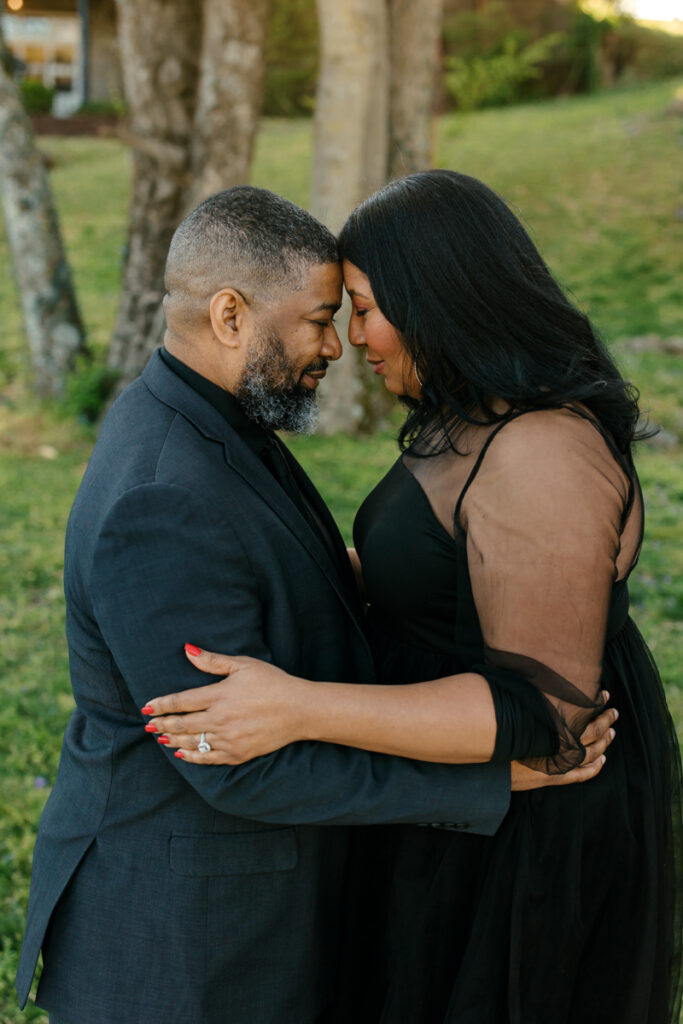 Engaged couple standing forehead to forehead at Lighthouse on the Lake in Hendersonville, TN