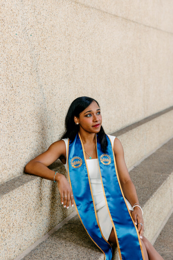 College senior sitting at The Parthenon at Centennial Park