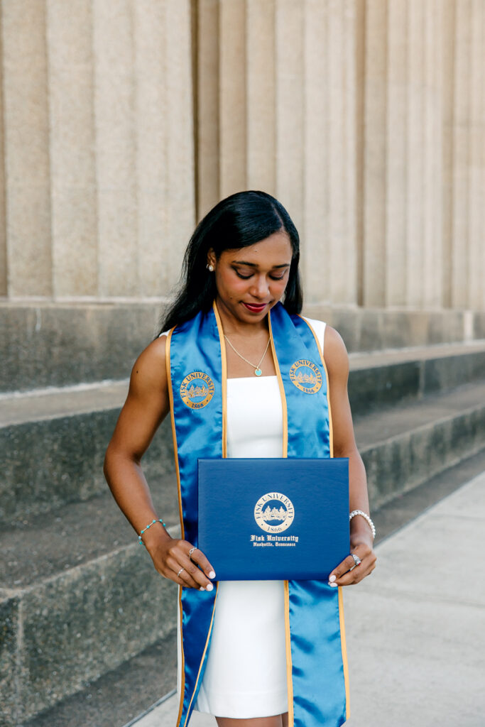Graduating senior gazing down at her diploma